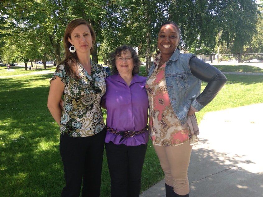 caption: Concerned neighbors in Othello Park, from left, Sarah Valenta, program coordinator for HomeSight, Daphne Schneider, co-chair of the Othello Park Alliance and Patrice Thomas, Community and Economic Development Assistant at Southeast Effective Development (SEED).