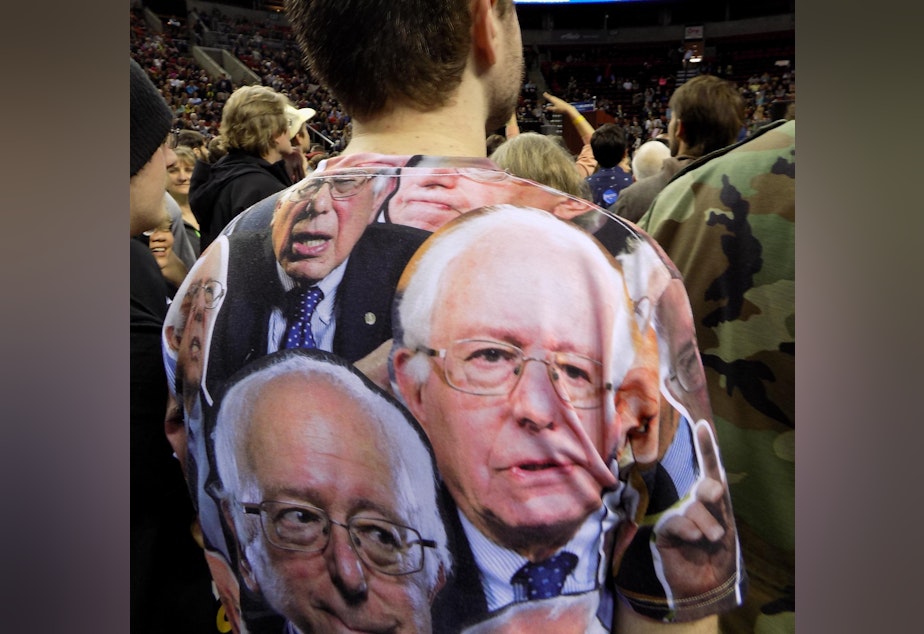 caption: Bernie Sanders supporter wears camouflage shirt to a Sanders rally at the Key Arena, March 20, 2016.