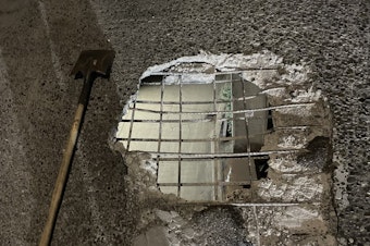 caption: A 4x5 foot hole in an onramp between the West Seattle Bridge and northbound Highway 99 in Seattle. 