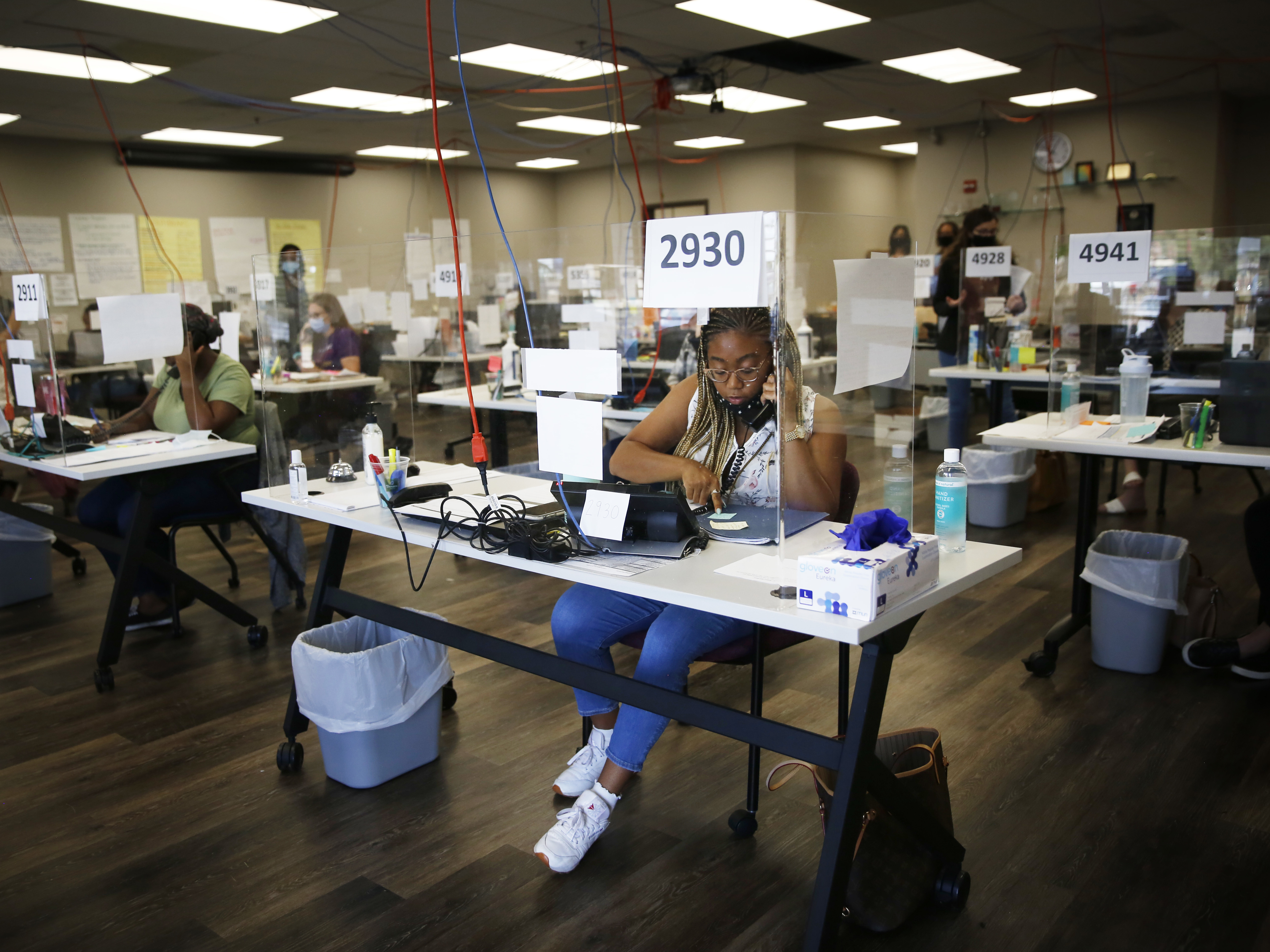caption: Shelby Dorsey, a contact tracer and a senior studying theater at the University of Illinois at Urbana-Champaign, makes calls at the local public health department. "Were not here to chastise," she says, "we're here to help."