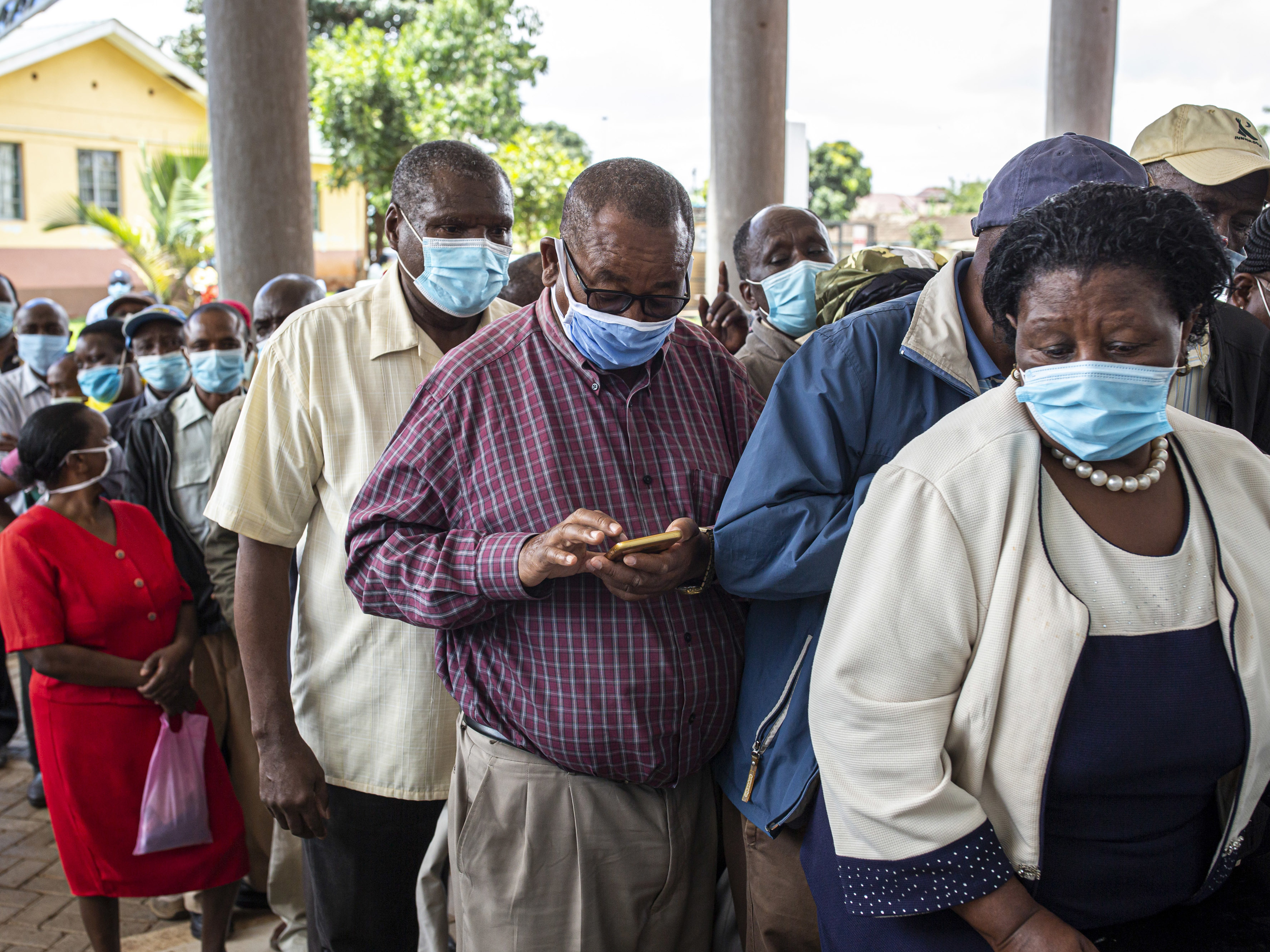 caption: Vaccine doses are in short supply in African countries — and even when they arrive, there may not be a way to get them into people's arms in a timely fashion. Above: People wait to get vaccinated at a hospital in Thika, Kenya, in March.