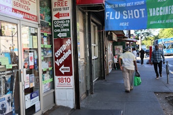 caption: Lab data suggests the new COVID-19  booster shots should protect against a variant that concerns scientists. The boosters should be widely available this fall at pharmacies, like the one seen in the Flatbush neighborhood of Brooklyn borough in New York City.