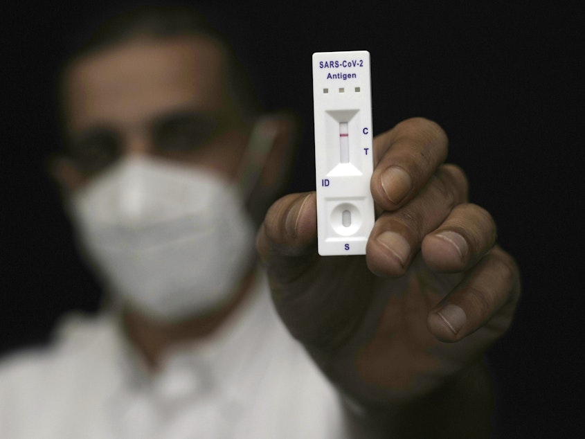 caption: Rapid antigen tests are ubiquitous, but some Americans have learned the hard way that a negative test result isn't necessarily the final word.