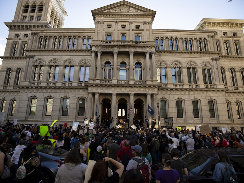 caption: Demonstrators gather outside City Hall in Louisville, Ky., on May 29 to protest of police violence.