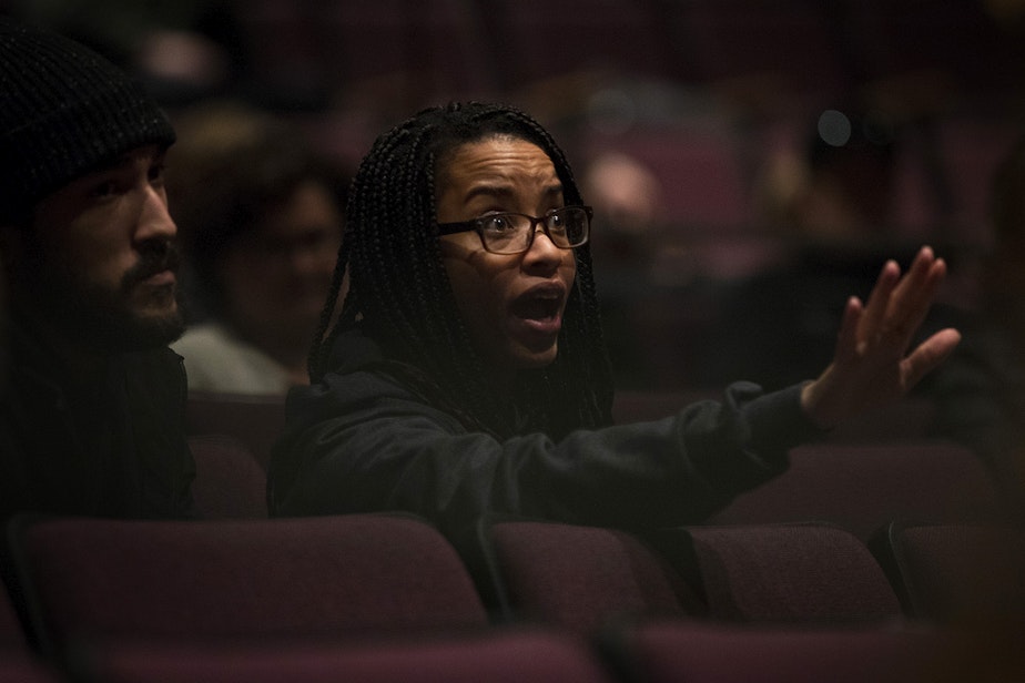 caption: Tierra Johnson reacts to statements made by Seattle Public School officials during a public meeting to address concerns about abusive teachers on Thursday, February 13, 2020 at Garfield High School in Seattle. 