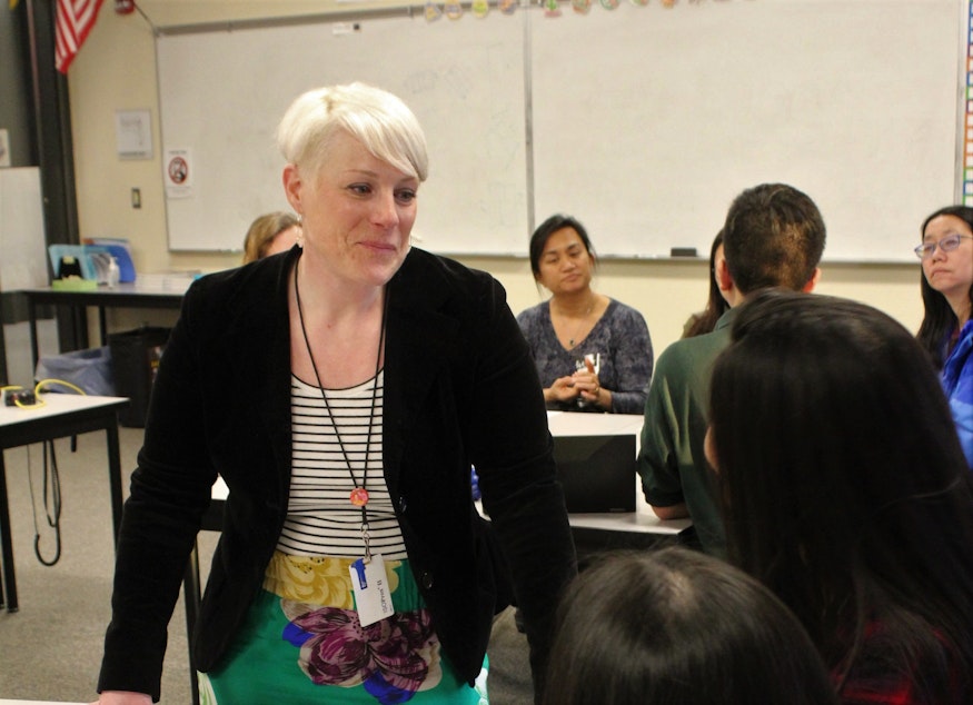 caption: Sammamish High School health teacher Karissa Stay speaks with students about their mental health presentations during the school's recent Health and Wellness Night 