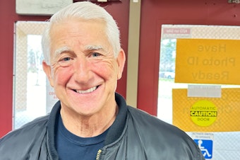 caption: Dave Reichert after firing up a crowd of fellow Republicans at Kamiakin Middle School in Kirkland, wearing his old leather King County Sheriff's jacket.