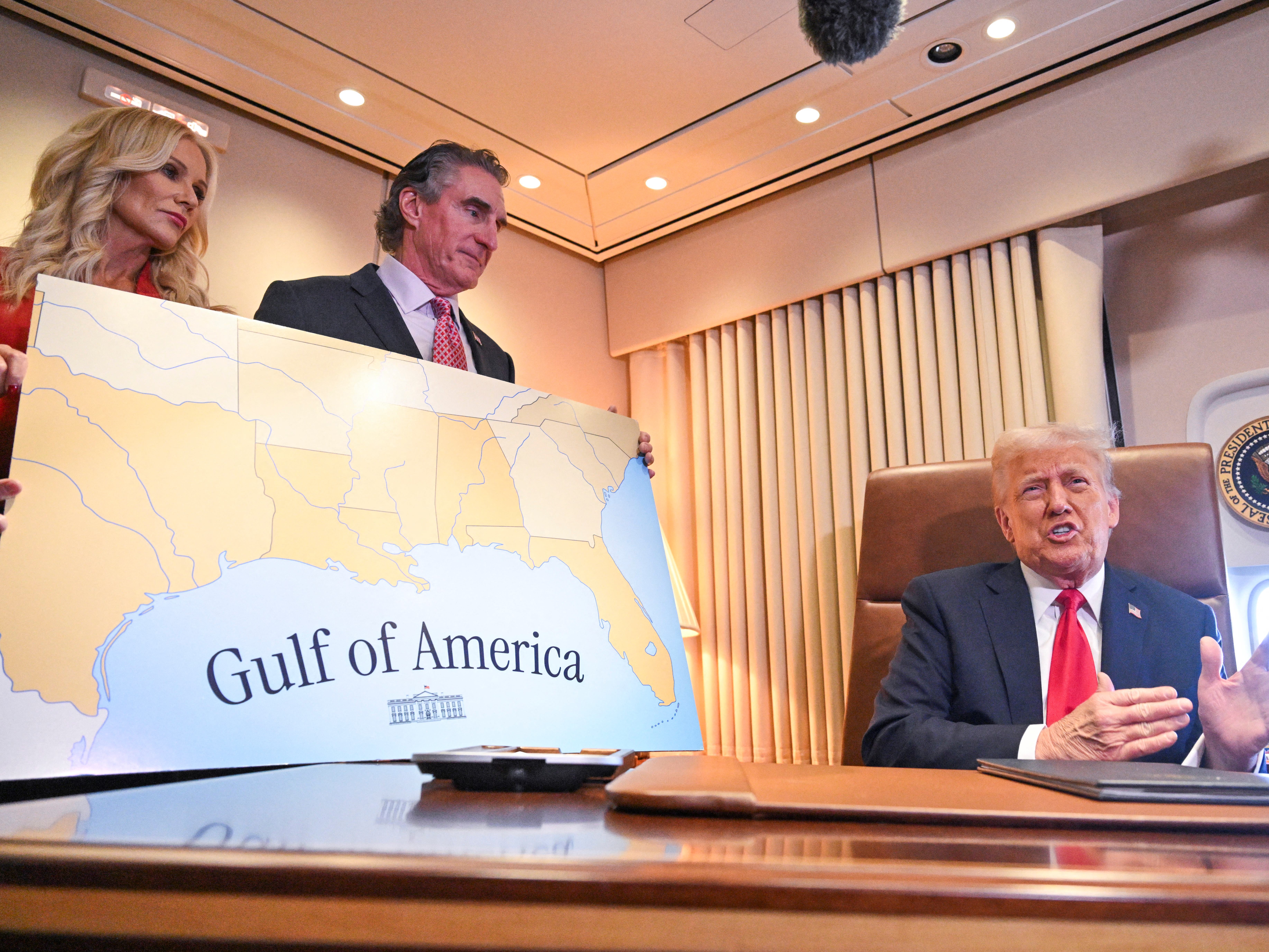 caption: President Trump speaks to the press before signing a proclamation renaming the Gulf of Mexico as the Gulf of America aboard Air Force One en route to New Orleans, Louisiana on Feb. 9, 2025.