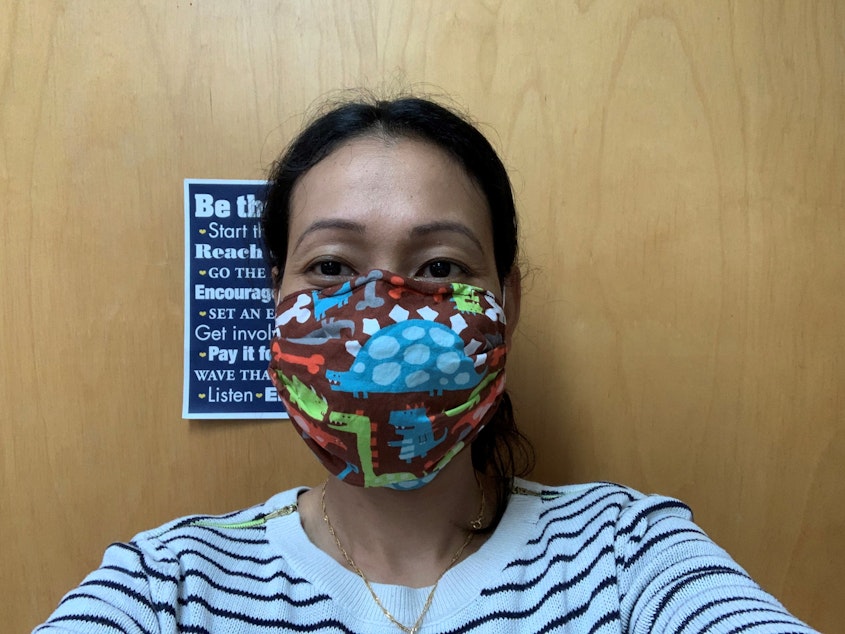 caption: Dental assistant Anita Laigo models a mask she made that's meant to replace an N95 in an emergency situation. Inside is part of an air conditioner filter from Home Depot. 