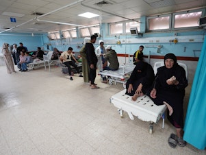 caption: Palestinians receive medical care at the European hospital in Khan Younis in the southern Gaza Strip on Friday.