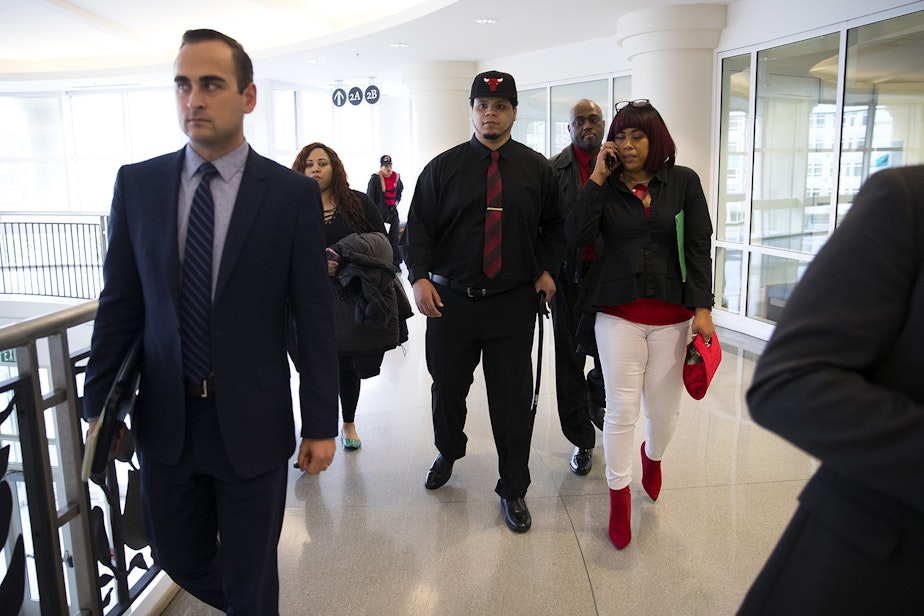 caption: DaShawn Horne, center, walks into the courtroom with his mother, LaDonna Horne, right, his mother's partner Rajah Cooper, second from right, and his caregiver Lynnae Fletcher, second from left, before Tuimauga's sentencing on Friday, November 16, 2018, at the Maleng Regional Justice Center in Kent.