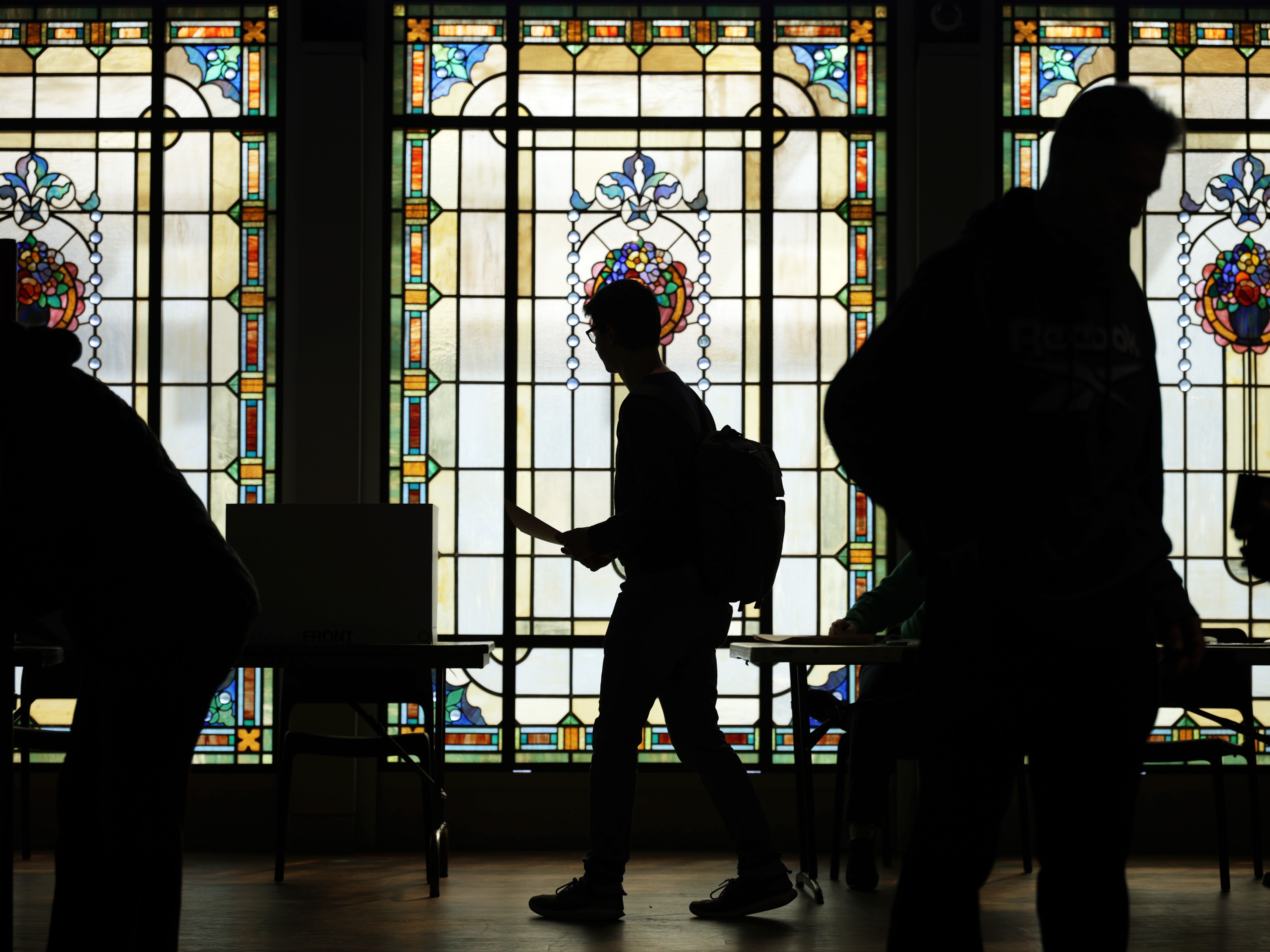 caption: Voters cast their ballots at a polling station on Nov. 4, 2025 in Arlington, Virginia.