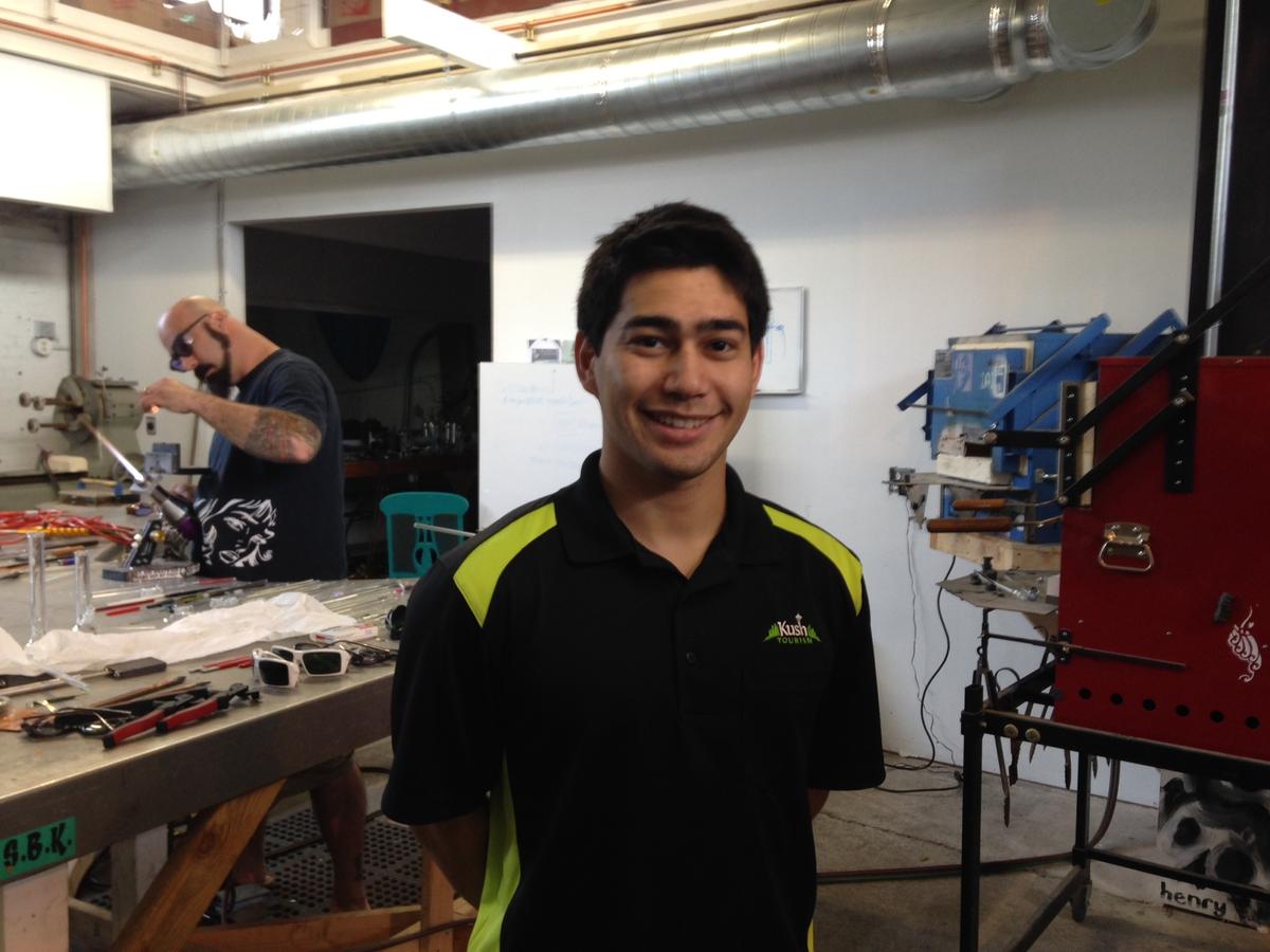 caption: Michael Gordon of Kush Tourism, at a glass-blowing studio that is a favorite stop for his tour groups.