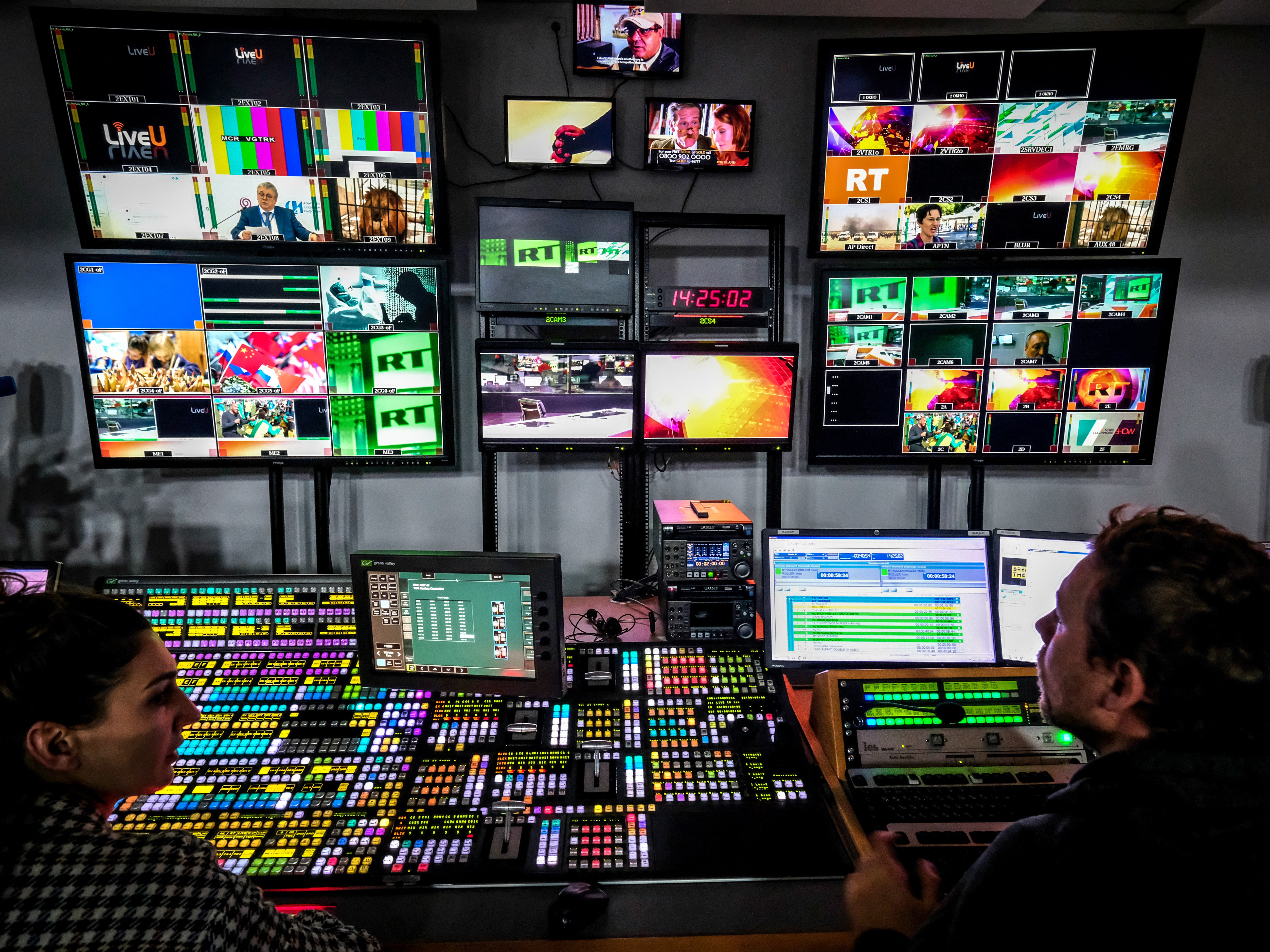 caption: A file photo from June 8, 2018 shows a control room at RT's Moscow studios. The state media organization has been accused by the Justice Department of covertly paying pro-Trump influencers in the U.S. 
