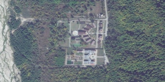 caption: A commercial satellite image of a facility known as Gornyi Kluch, or "Mountain Key," in October 2022. The camp is one of more than 40 locations in Russia verified by a team of researchers at Yale University to have been part of Russia's system of camps for and adoptions of children from Ukraine.