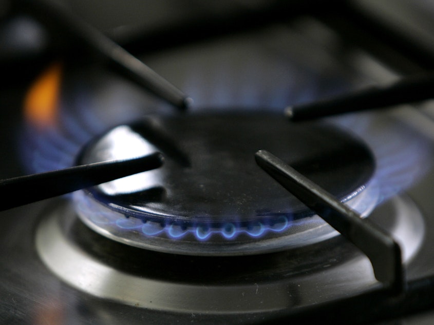 caption: A gas-lit flame burns on a stove. A California restaurant organization is suing Berkeley over the city's ban on natural gas, which is set to take effect in January, 2020.