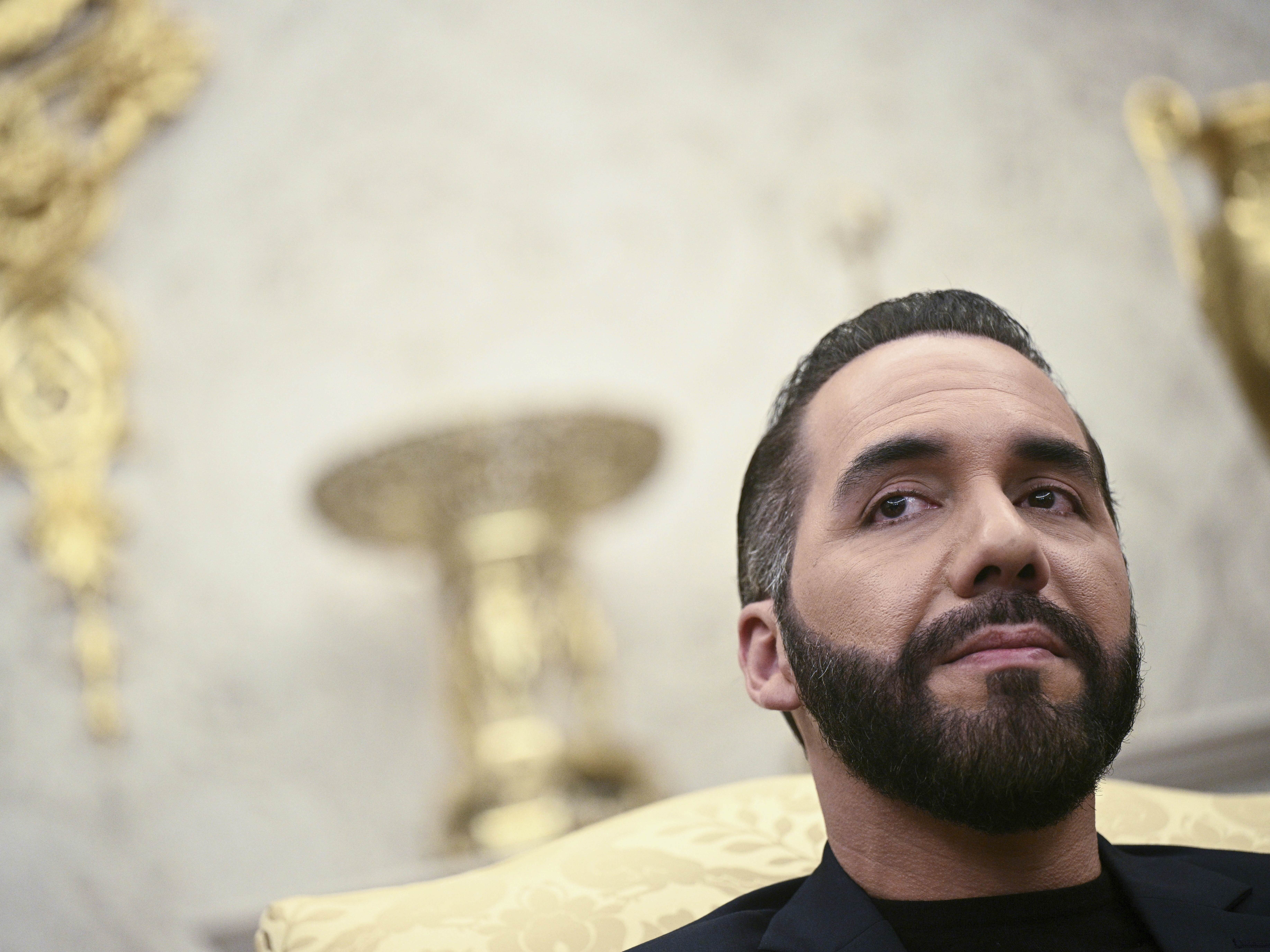 caption: El Salvador's President Nayib Bukele listens during a meeting with President Donald Trump in the Oval Office of the White House in Washington on Monday.