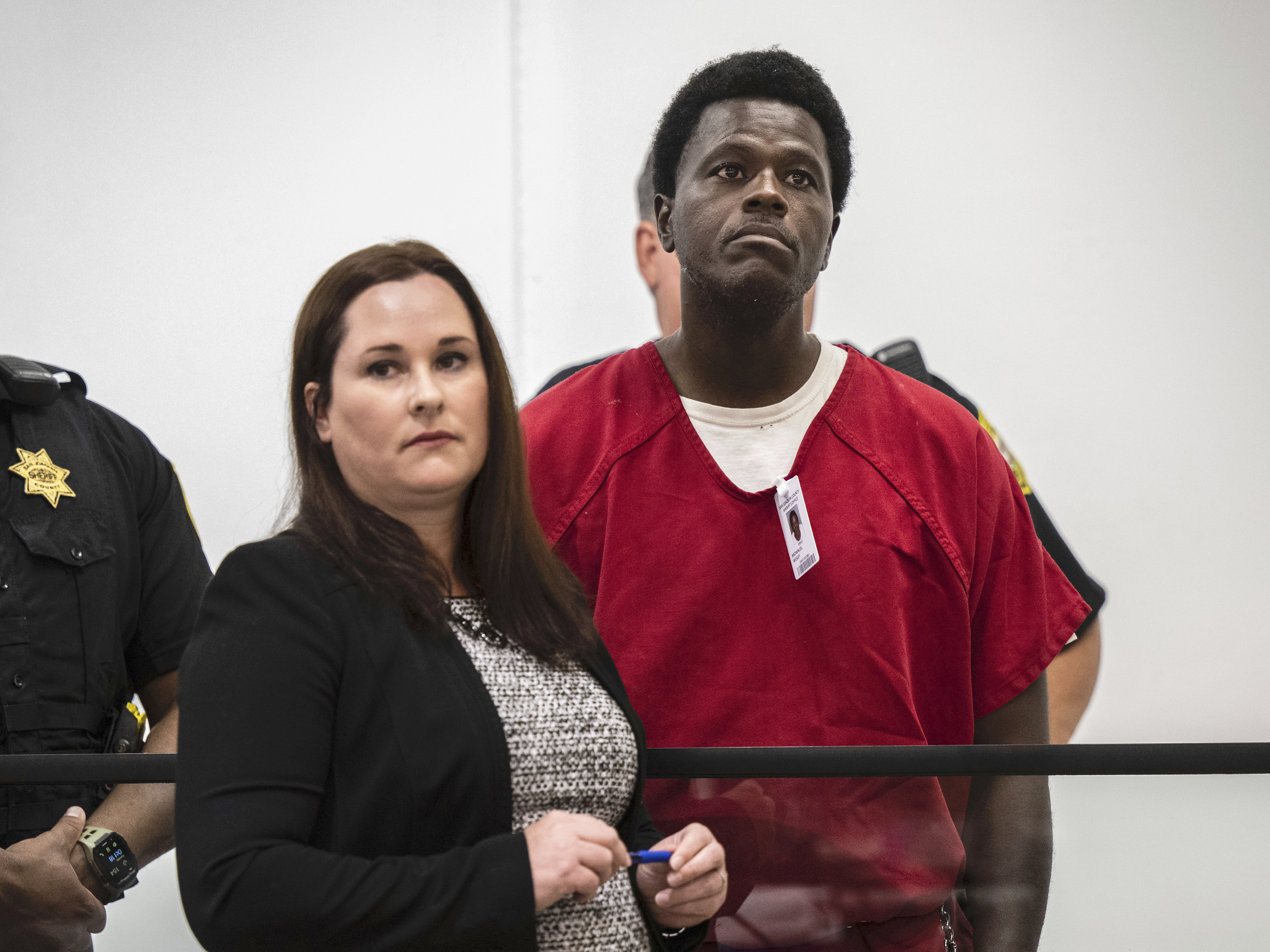 caption: Wesley Brownlee stands with public defender Allison Nobert during his arraignment in San Joaquin County Superior Court on Oct. 18. Brownlee has been charged this week in four additional slayings.