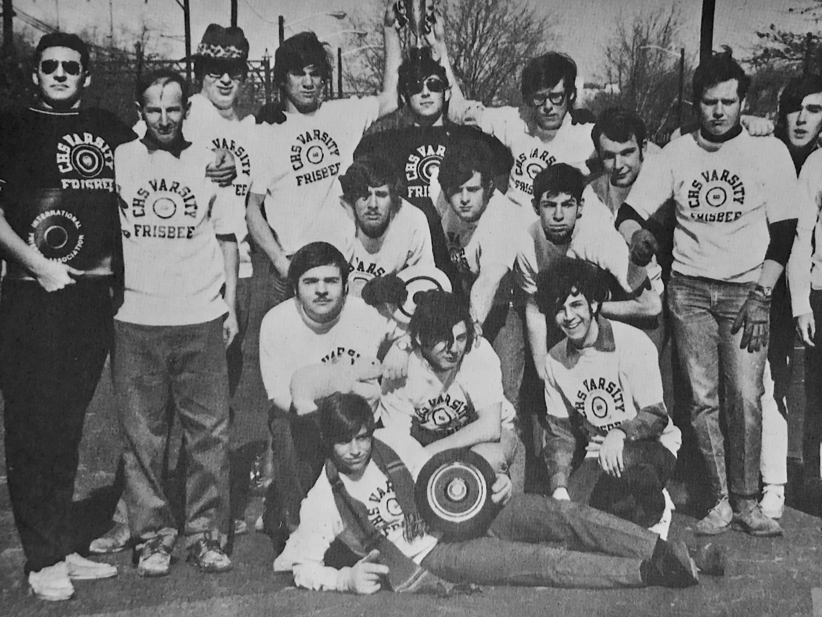caption: Joel Silver is far left in the black t-shirt and sunglasses. And Buzzy Hellring is in the middle (under the cup) also in the black t-shirt and sunglasses.