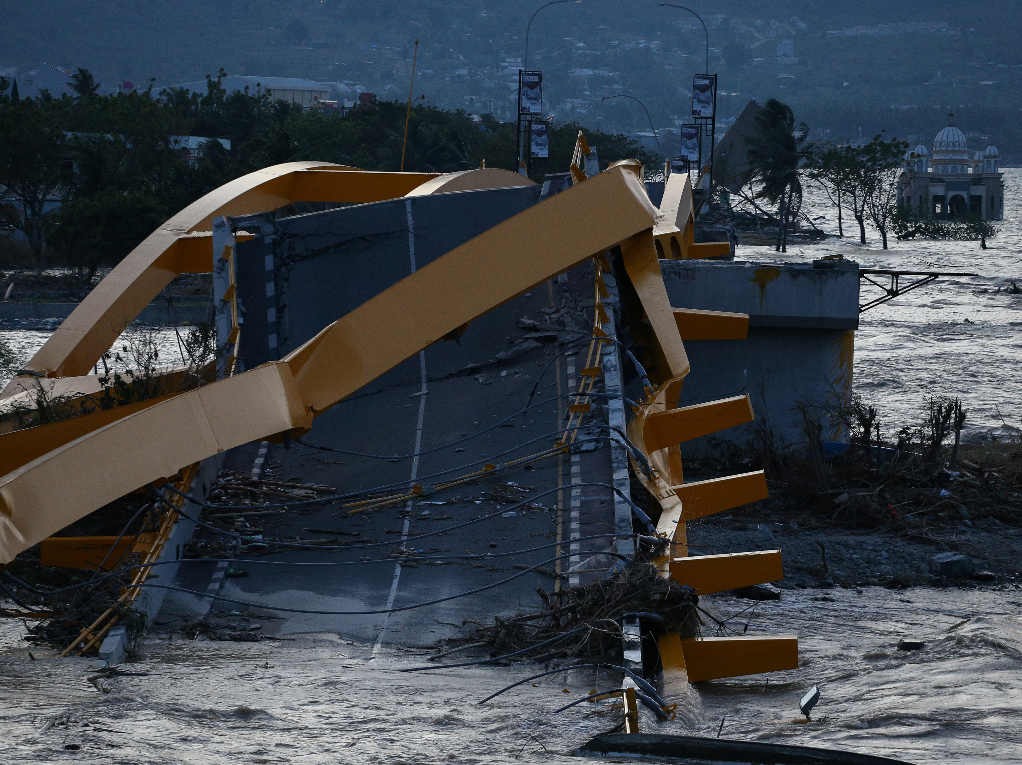 caption: A bridge was wrecked at the city of Palu, after an earthquake and tsunami hit the area in Central Sulawesi, Indonesia.