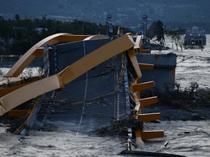 caption: A bridge was wrecked at the city of Palu, after an earthquake and tsunami hit the area in Central Sulawesi, Indonesia.