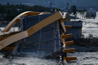 caption: A bridge was wrecked at the city of Palu, after an earthquake and tsunami hit the area in Central Sulawesi, Indonesia.
