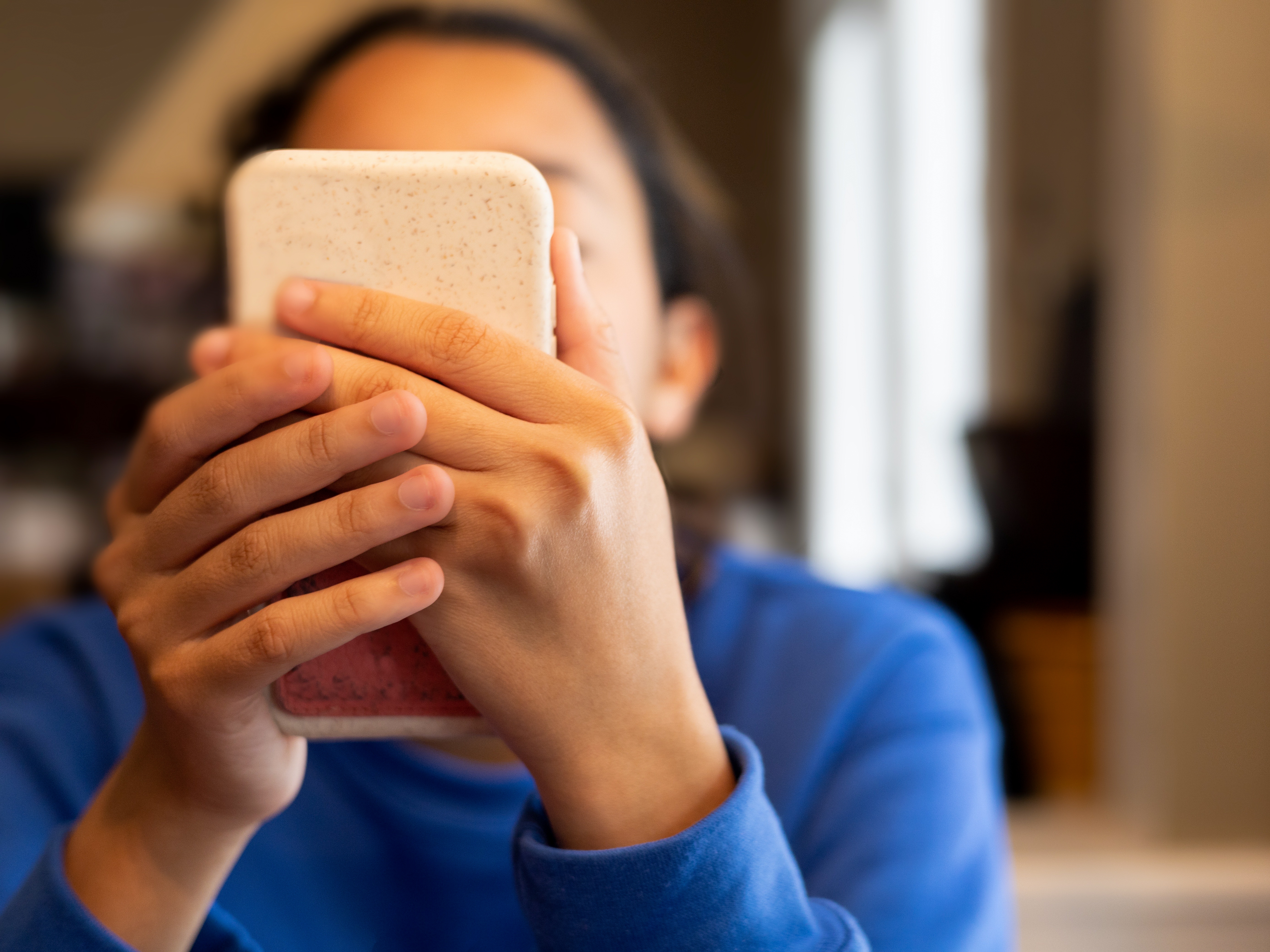 caption: The study asked about signs of addiction to mobile phones, social media and video games. Those signs can include being preoccupied thinking about them and being unable to cut down on using them.