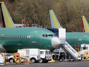 caption: Boeing said on Sunday that it was aware of problems with a key safety indicator in 2017, but it didn't inform airlines or the FAA until after the Lion Air crash a year later. Here, 737 Max jets built for American Airlines (left) and Air Canada are parked at the airport adjacent to a Boeing production facility in Renton, Wash., in April.