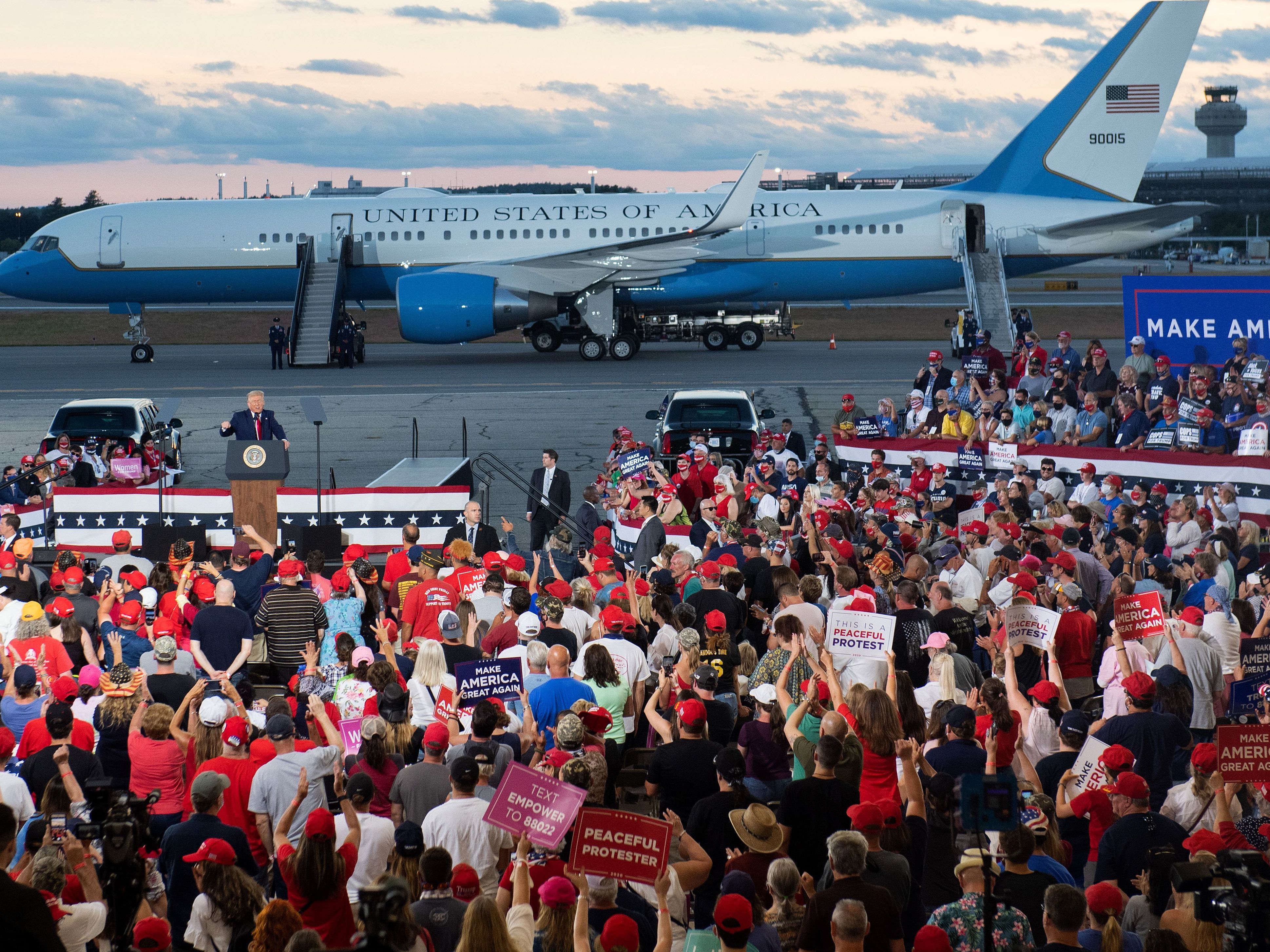 caption: President Trump addresses supporters during a campaign rally at Manchester, N.H. during the ongoing pandemic.