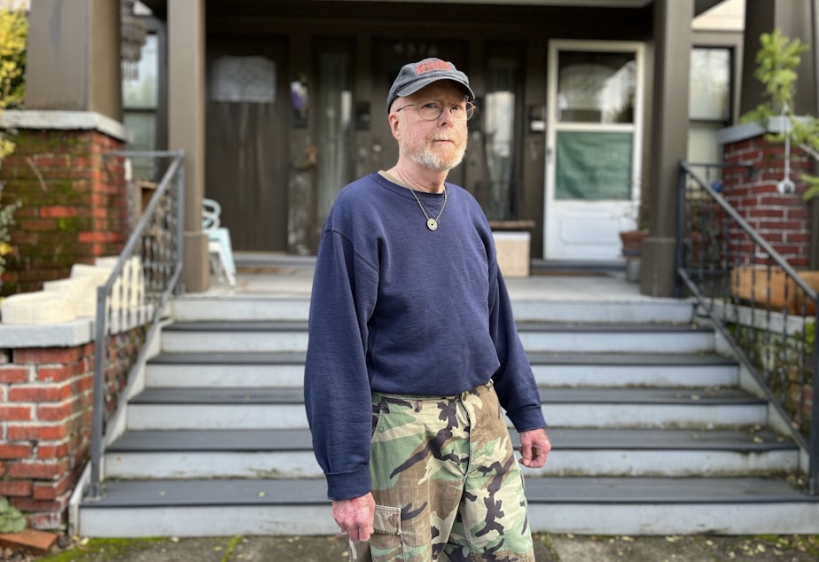 caption: Kevin Murphy, in front of the apartment building where he rents. He calls his building "The Cowboy Hotel."