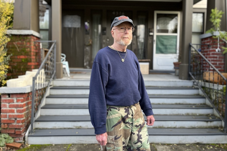 caption: Kevin Murphy, in front of the apartment building where he rents. He calls his building "The Cowboy Hotel."