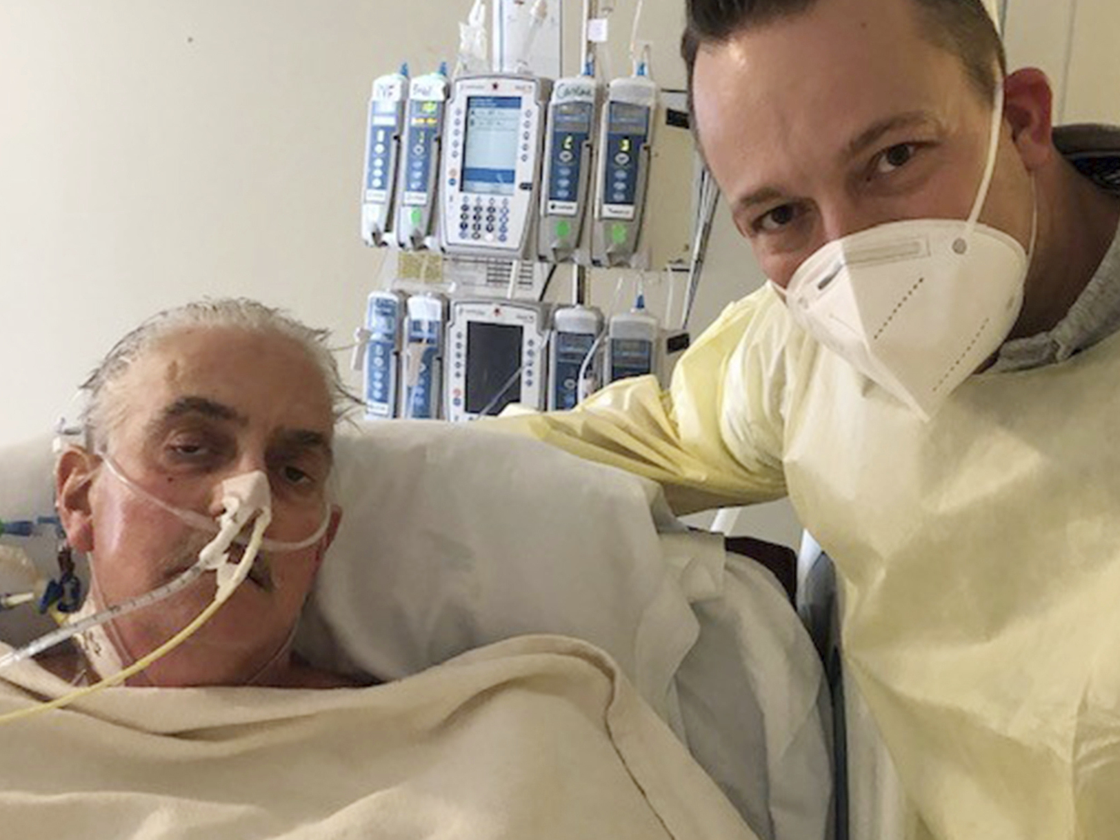caption: David Bennett Jr. (right) stands next to his father at a Baltimore hospital on Jan. 12, five days after doctors transplanted a pig heart into the older Bennett, in a last-ditch effort to save his life.
