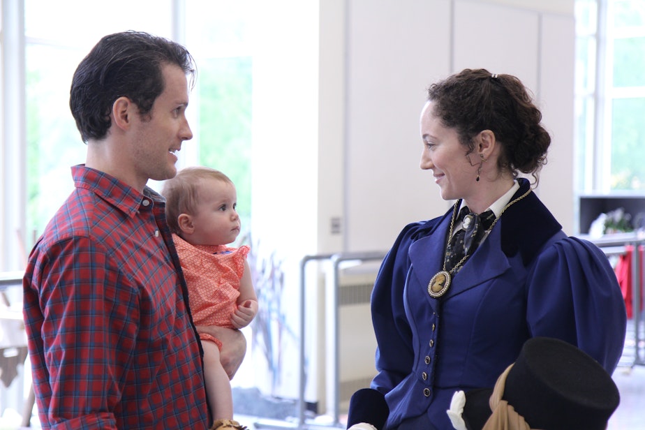 caption: Sarah Orza, costumed for her role in the ballet "Giselle," with husband Seth and baby Lola