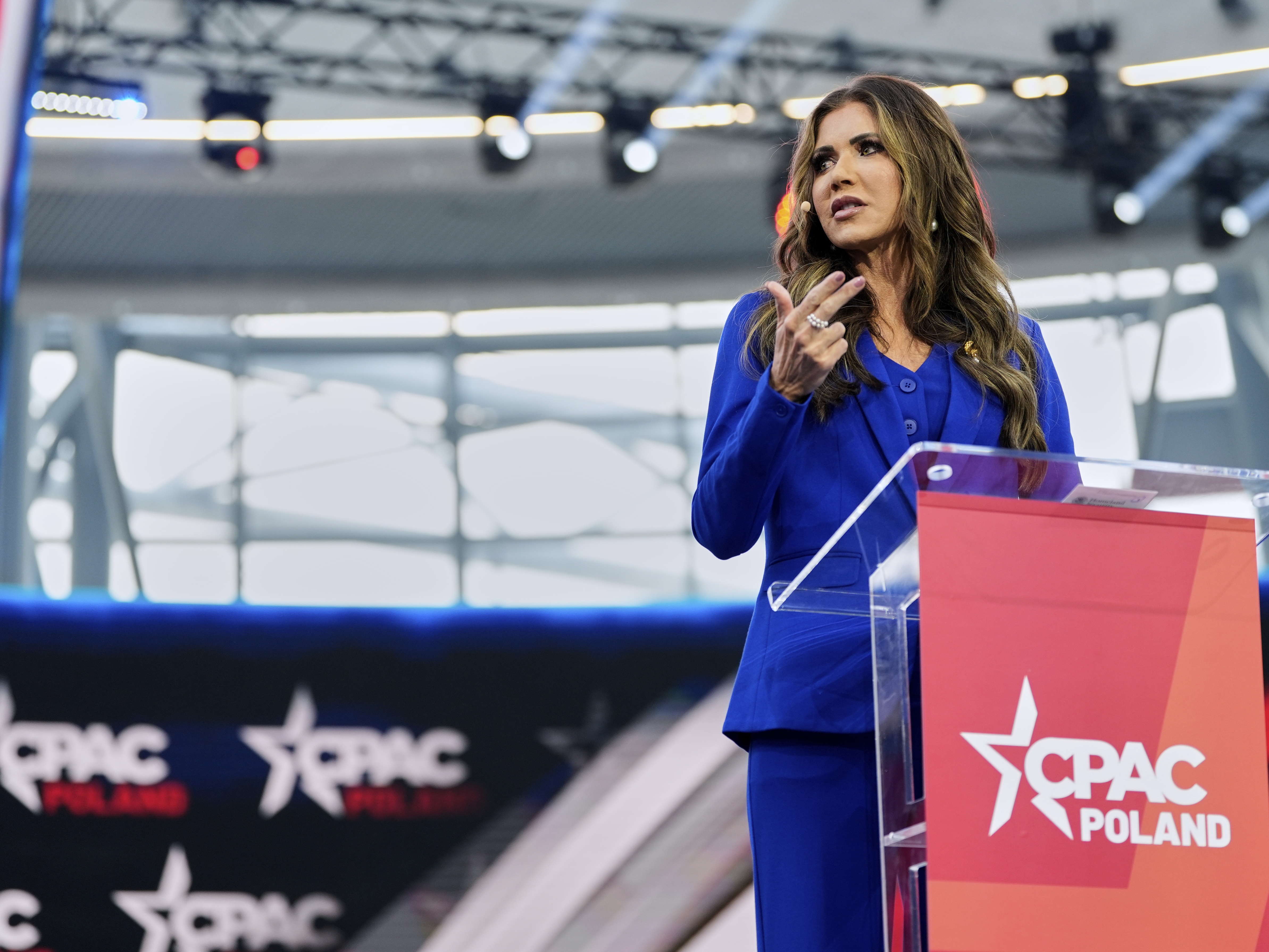 caption: Homeland Security Secretary Kristi Noem speaks at the Conservative Political Action Conference, CPAC, on Tuesday, in Jasionka, Poland.