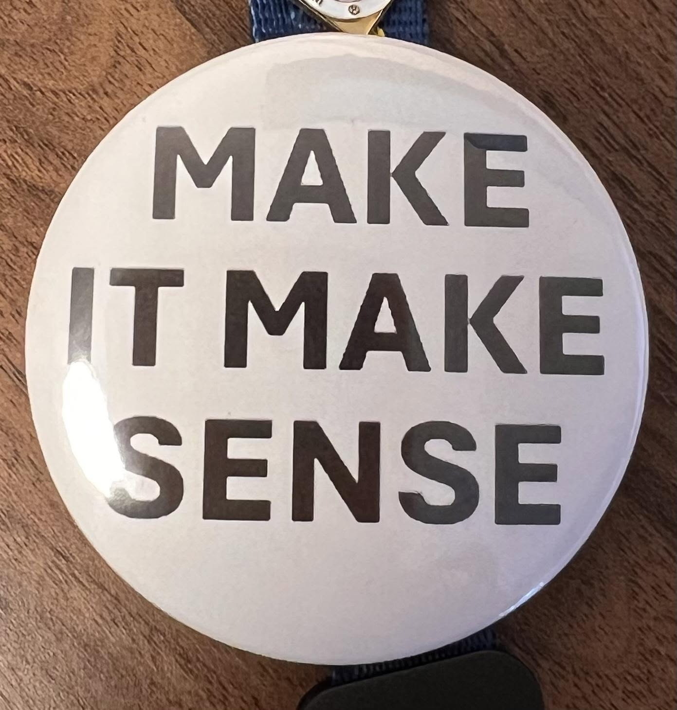 caption: King County employees wore these buttons to protest what they say is a misguided return-to-office mandate during a March 17, 2026, meeting, according to Teamsters 117. 