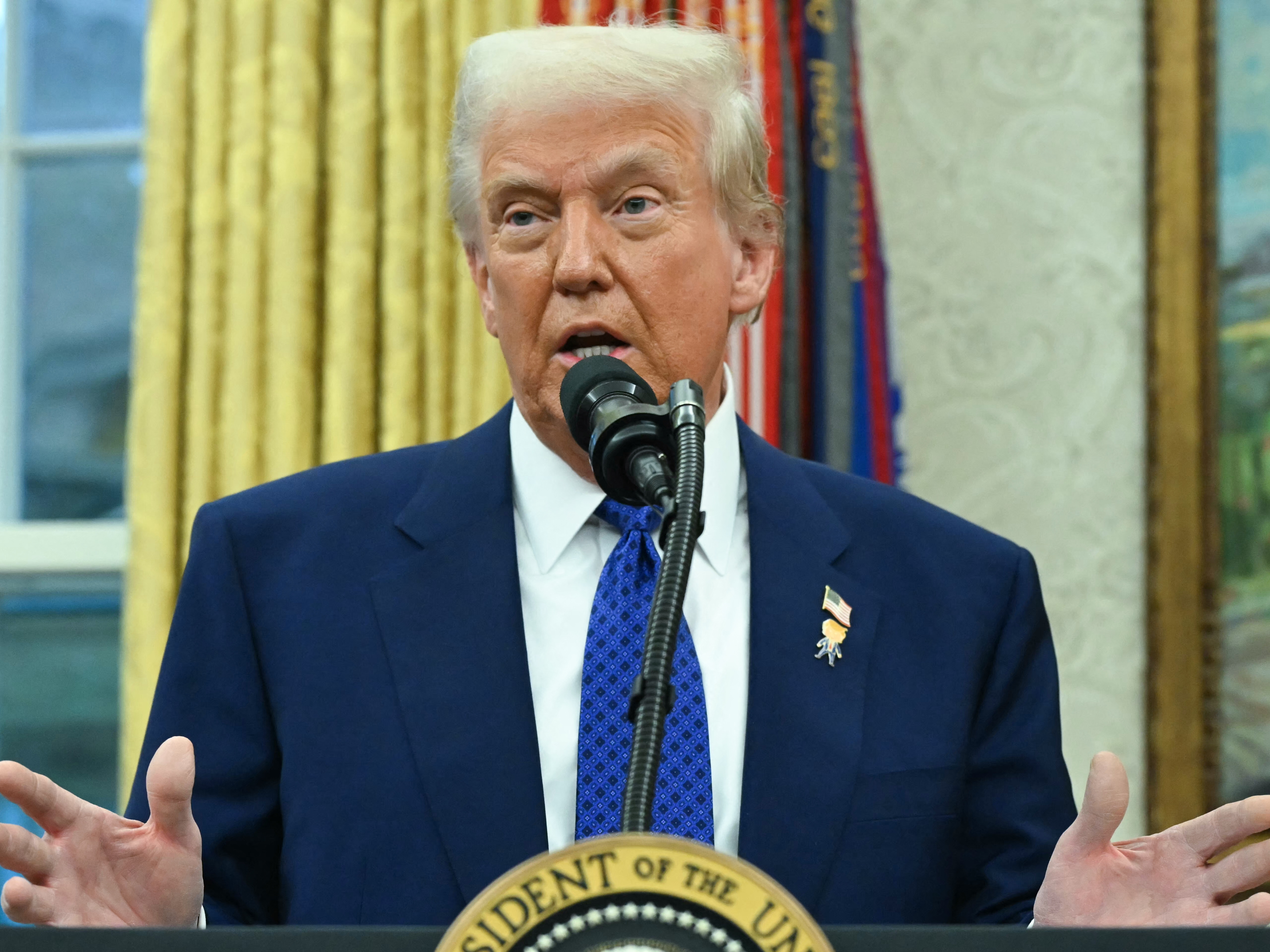 caption: President Trump is considering additional taxes on imported products, saying U.S. tariffs should be as high as those in other countries. Pictured is Trump speaking from the Oval Office of the White House in Washington, D.C., on Feb. 12, 2025.