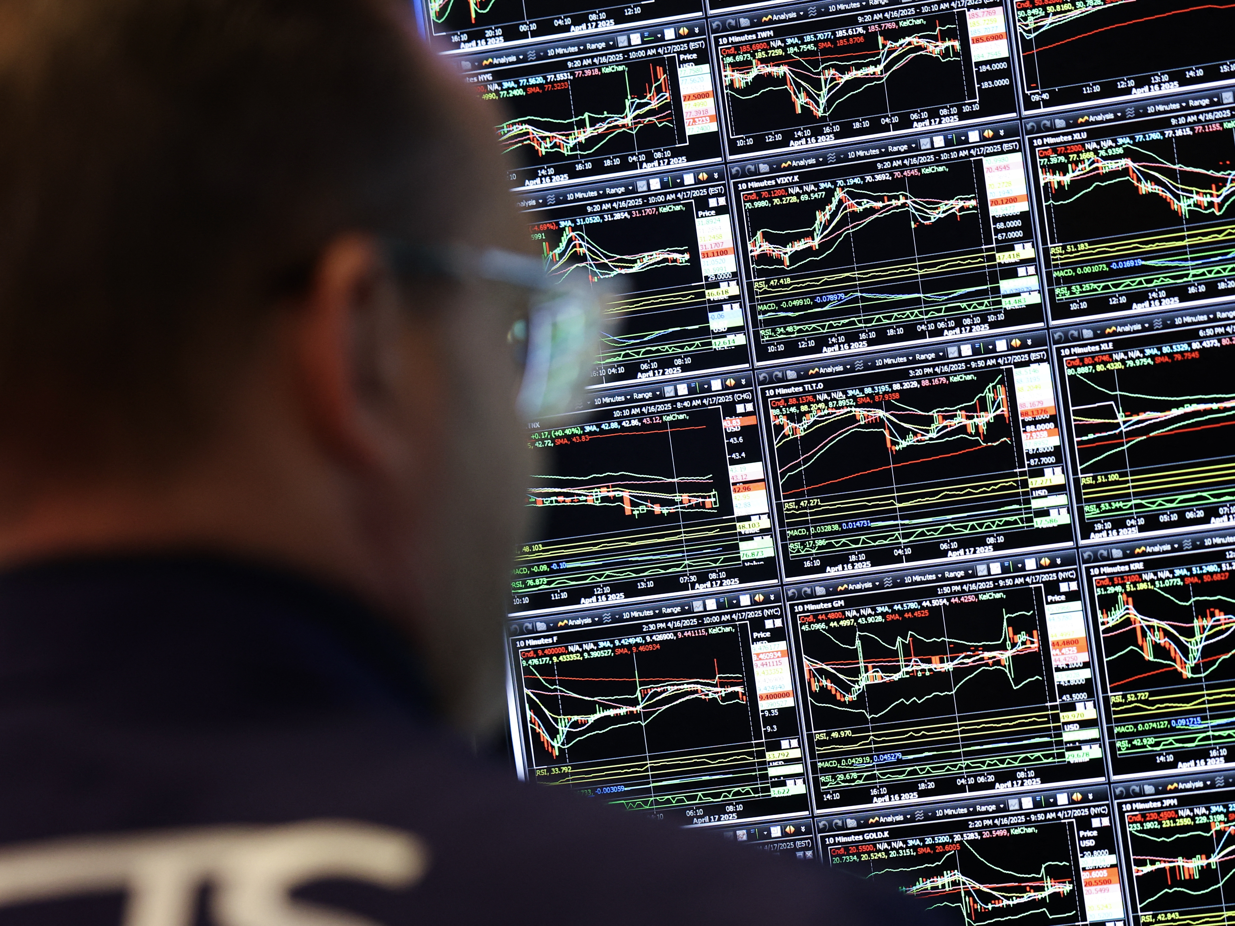 caption: A trader on the floor of the New York Stock Exchange.