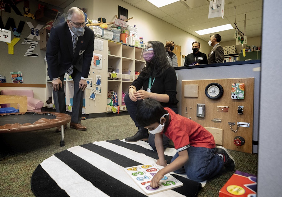 caption: Washington State Governor Jay Inslee speaks with special ed Pre-K teacher Michelle Ling in her classroom at Phantom Lake Elementary School in Bellevue, Wash. Tuesday, March 2, 2021. 