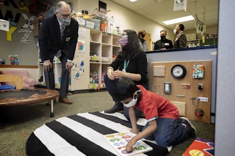 caption: Washington State Governor Jay Inslee speaks with special ed Pre-K teacher Michelle Ling in her classroom at Phantom Lake Elementary School in Bellevue, Wash. Tuesday, March 2, 2021. 