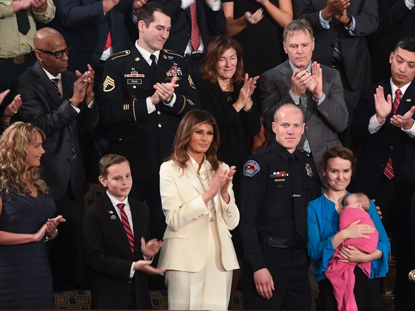 caption: First lady Melania Trump and guests watch President Trump deliver his first State of the Union address to Congress in January 2018.