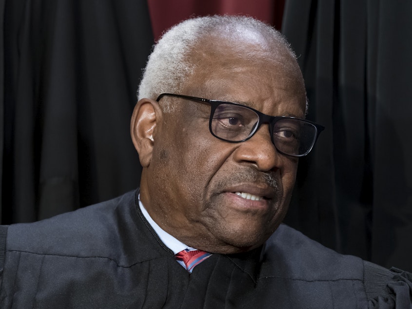 caption: Justice Clarence Thomas joins other members of the Supreme Court as they pose for a new group portrait, at the Supreme Court building in Washington, Friday, Oct. 7, 2022.
