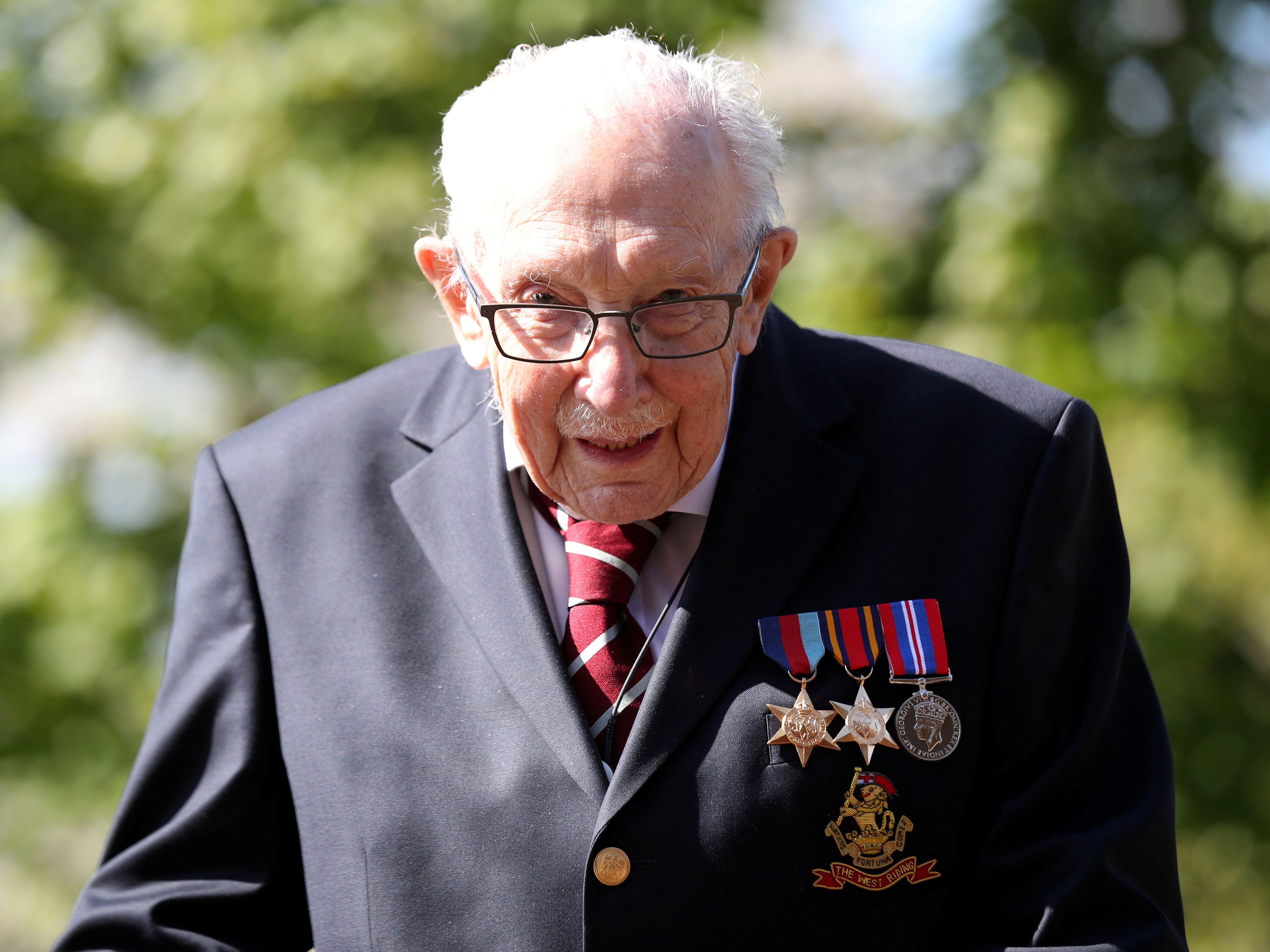 caption: Capt. Tom Moore, 100, is being awarded a knighthood by Queen Elizabeth II after raising more than $39 million in charity for medical workers. Moore walked 100 laps in his garden to earn donations.