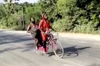 caption: In this screengrab from video posted by BBC News Hindi,15-year-old Jyoti Kumari's rides with her father during their 700 mile-long journey to their family's village of Sirhulli in eastern India.