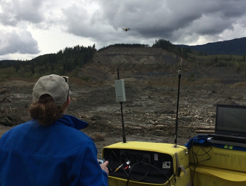 caption: Brittany Duncan of Roboticists Without Borders flies a drone to survey the Oso mudslide on April 23, 2014.