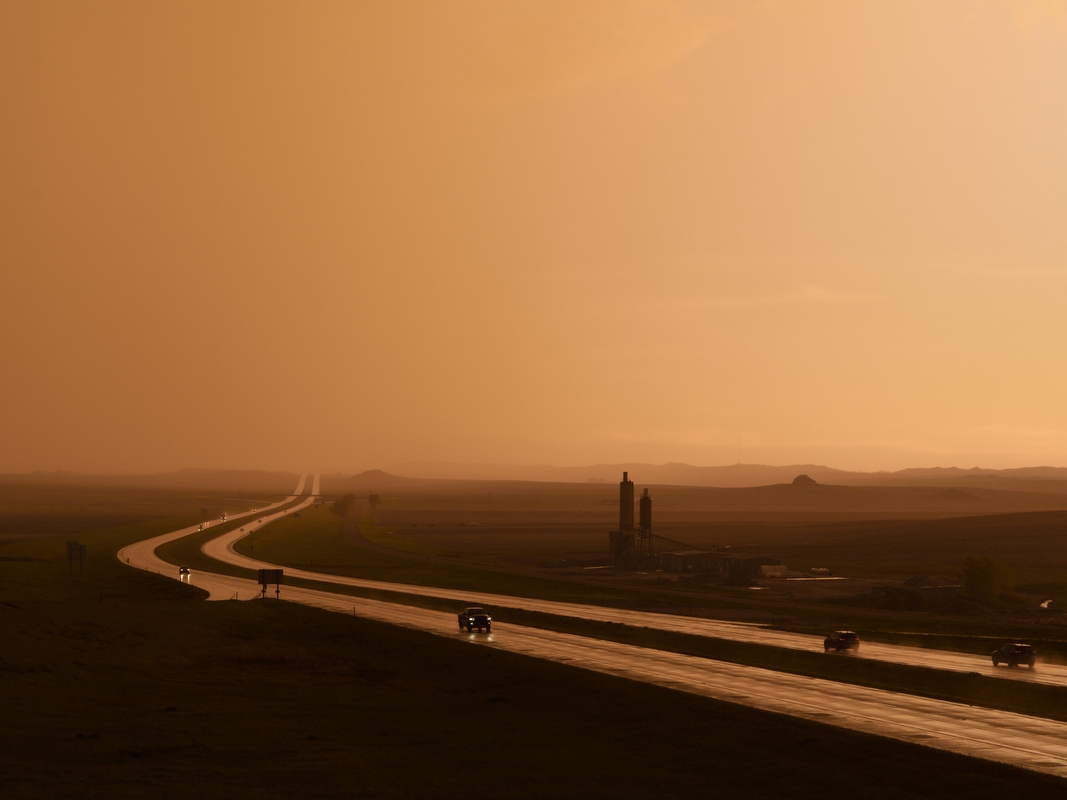 caption: A rainstorm passes over Interstate 94 in Morton County, N.D., on May 25. Inclement weather and long travel distances to medical providers present serious access barriers for seniors here, many of whom are not able to drive or are uncomfortable driving in low-visibility conditions. 