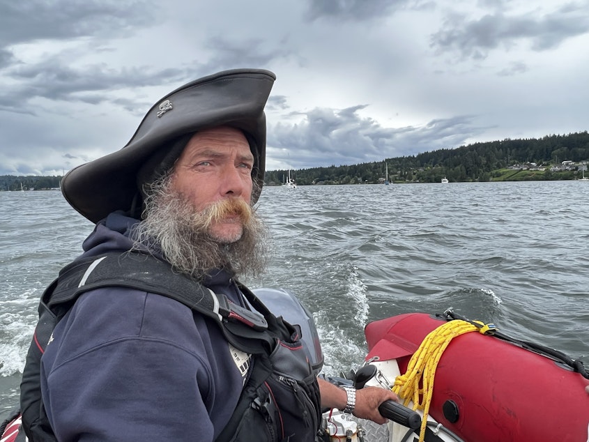 caption: Sir Thomas Gregory, who some call the "Pirate King," helps teach new liveaboards the ropes of living full-time on a boat.