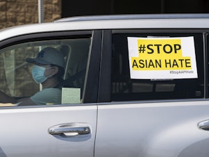 caption: Members of the Korean American Federation of Los Angeles drive with signs reading: "#Stop Asian Hate," in a caravan around Koreatown to denounce hate against the Asian American and Pacific Islander communities in Los Angeles on March 19, 2021.