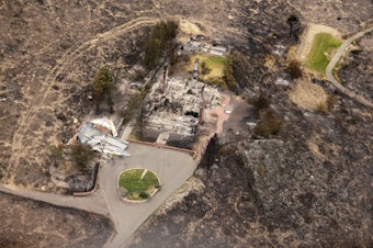 caption: In this July 24, 2014, the remains of structures that were destroyed by wildfires near Pateros, Wash. The Carlton Complex fire was the largest in Washington State history. 
