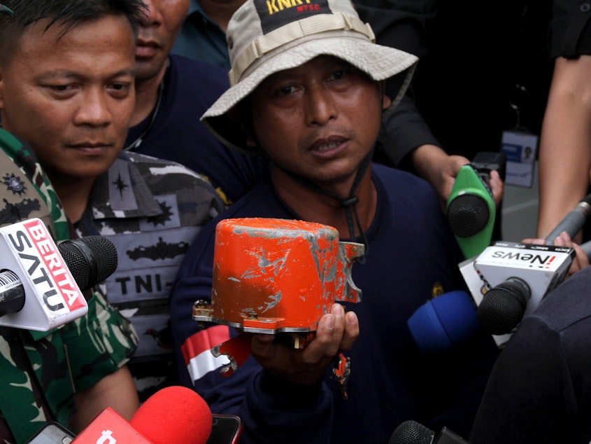 caption: The cockpit voice recorder from Lion Air Flight 610 is displayed by Indonesian navy personnel after the device's recovery on Monday.