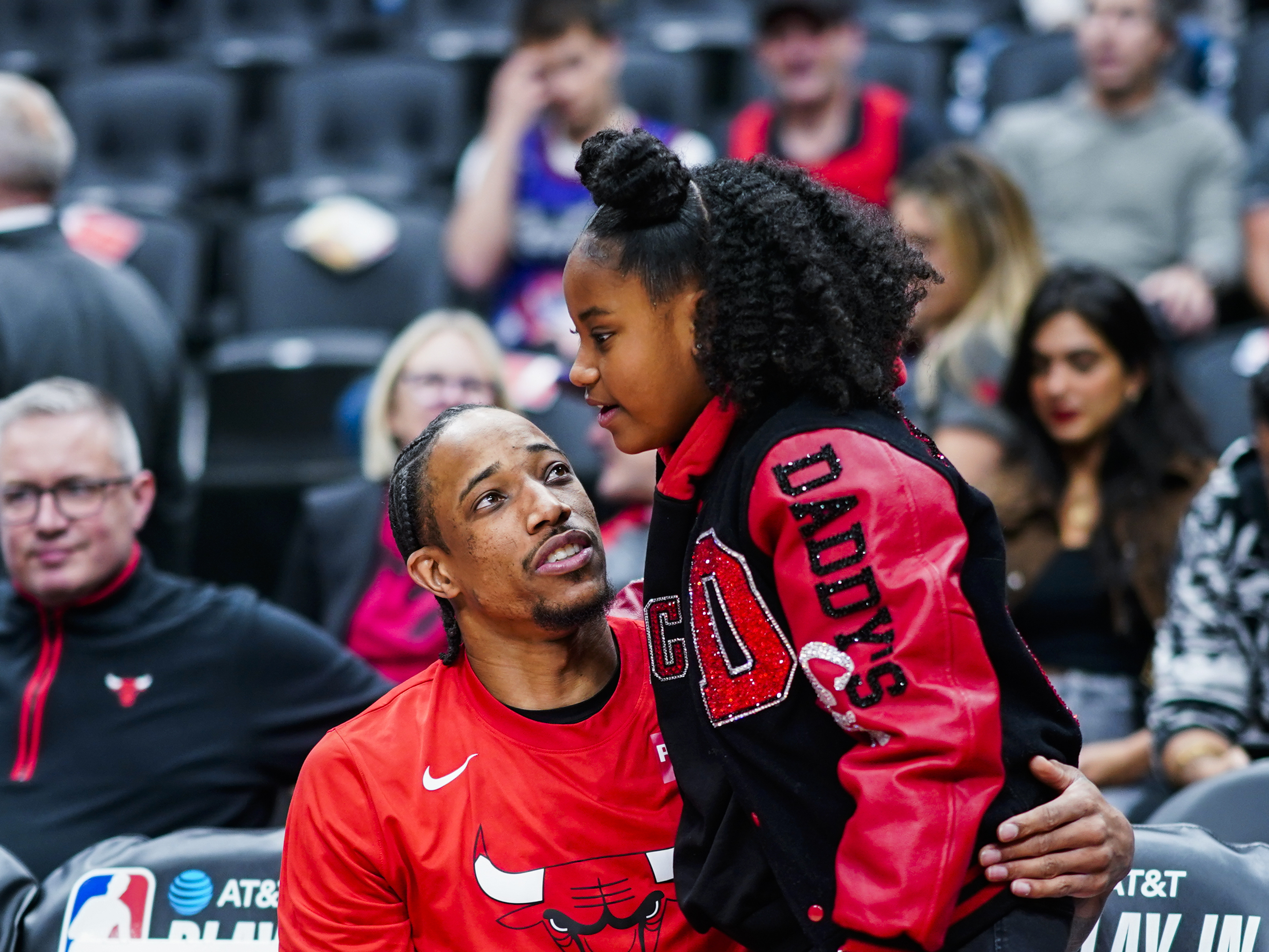 caption: DeMar DeRozan embraces his daughter Diar before the game against the Toronto Raptors at the Scotiabank Arena in Toronto, Ontario, Canada.